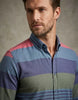 Man wearing a multicolored striped shirt against a neutral background