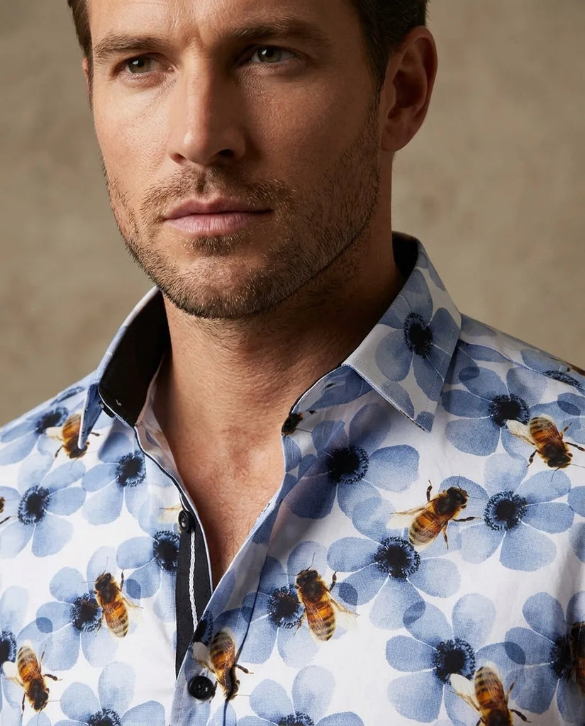 Man wearing a shirt with blue floral and bee pattern