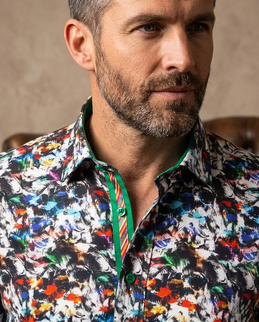 Man wearing a colorful patterned shirt against a neutral background