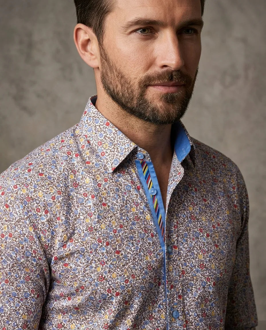 Man wearing a patterned shirt with a plain background