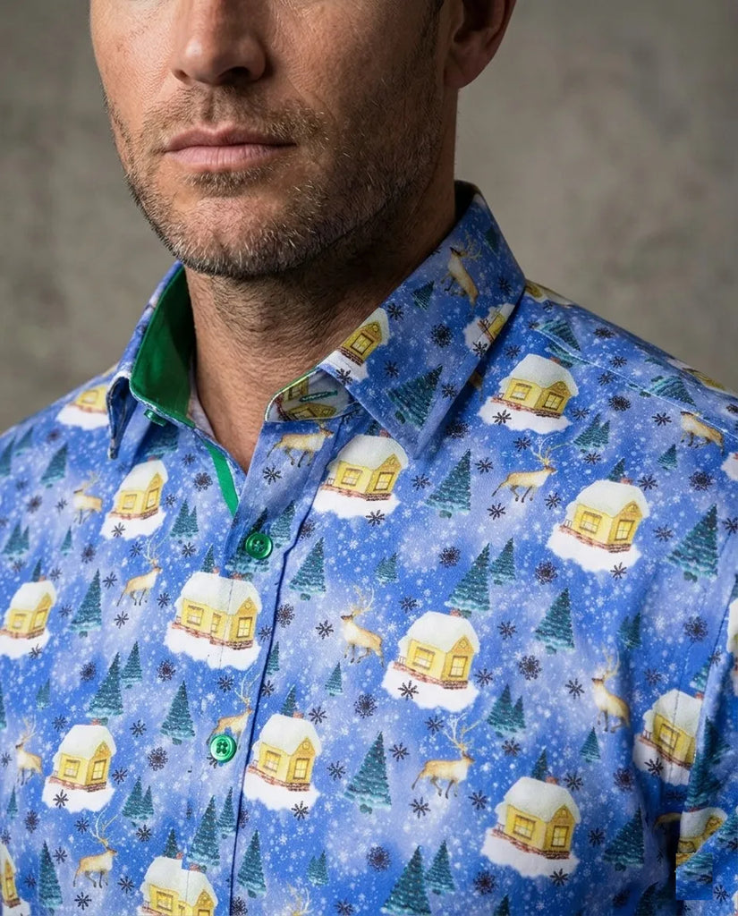 Man wearing a blue patterned shirt with winter-themed designs on a gray background