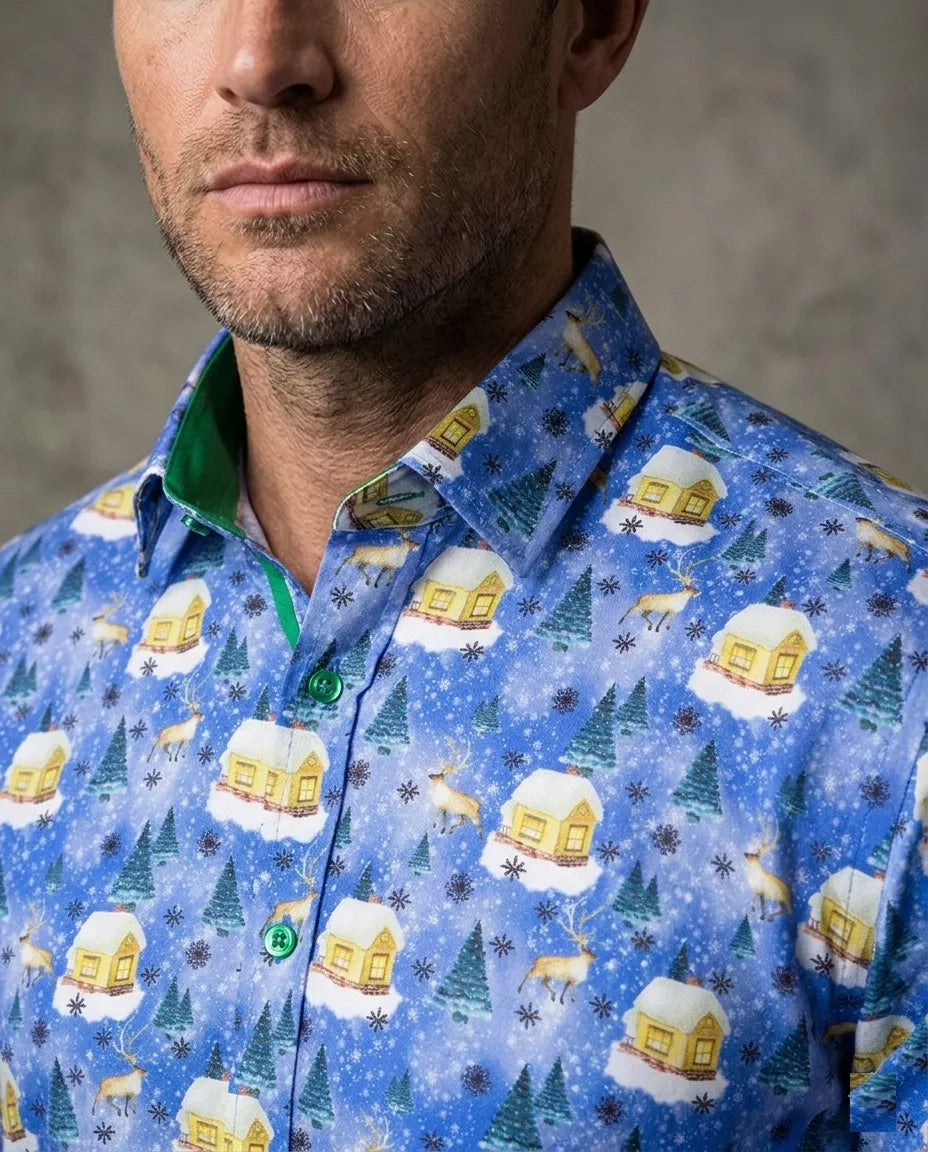 Man wearing a blue patterned shirt with winter-themed designs on a gray background