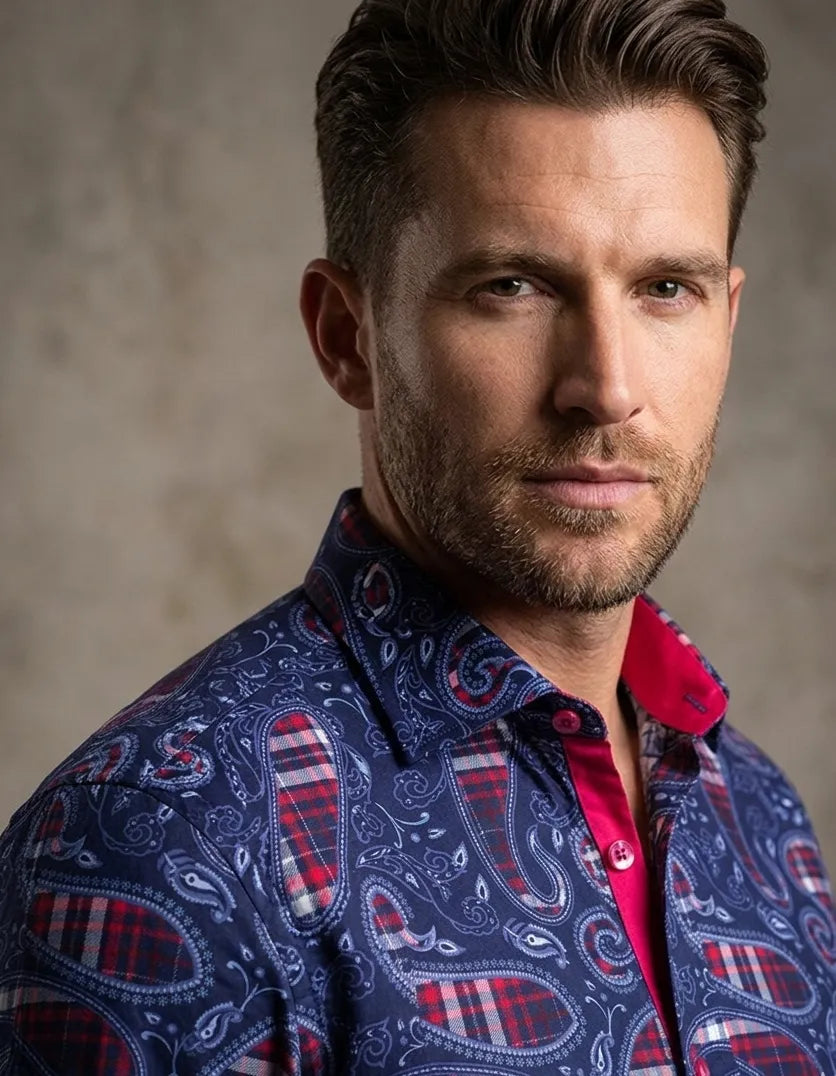 Man wearing a patterned shirt with a neutral background