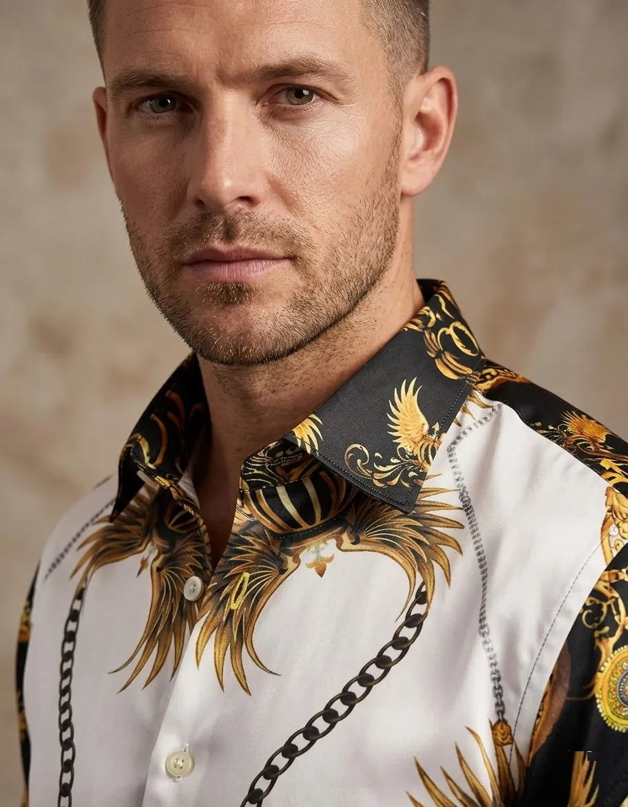 Man wearing a white shirt with gold and black patterned collar against a beige background