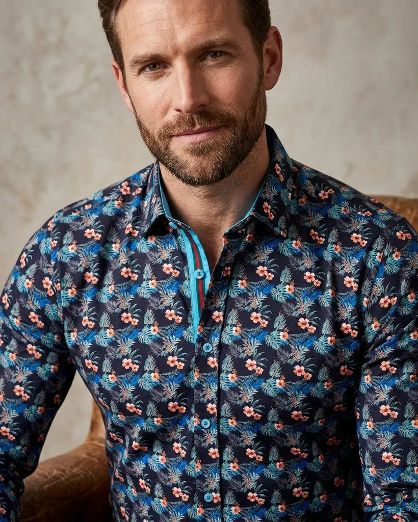 Man wearing a patterned shirt with a neutral background