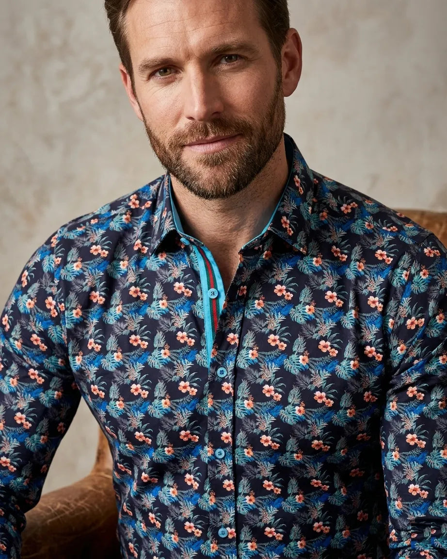 Man wearing a patterned shirt with a neutral background