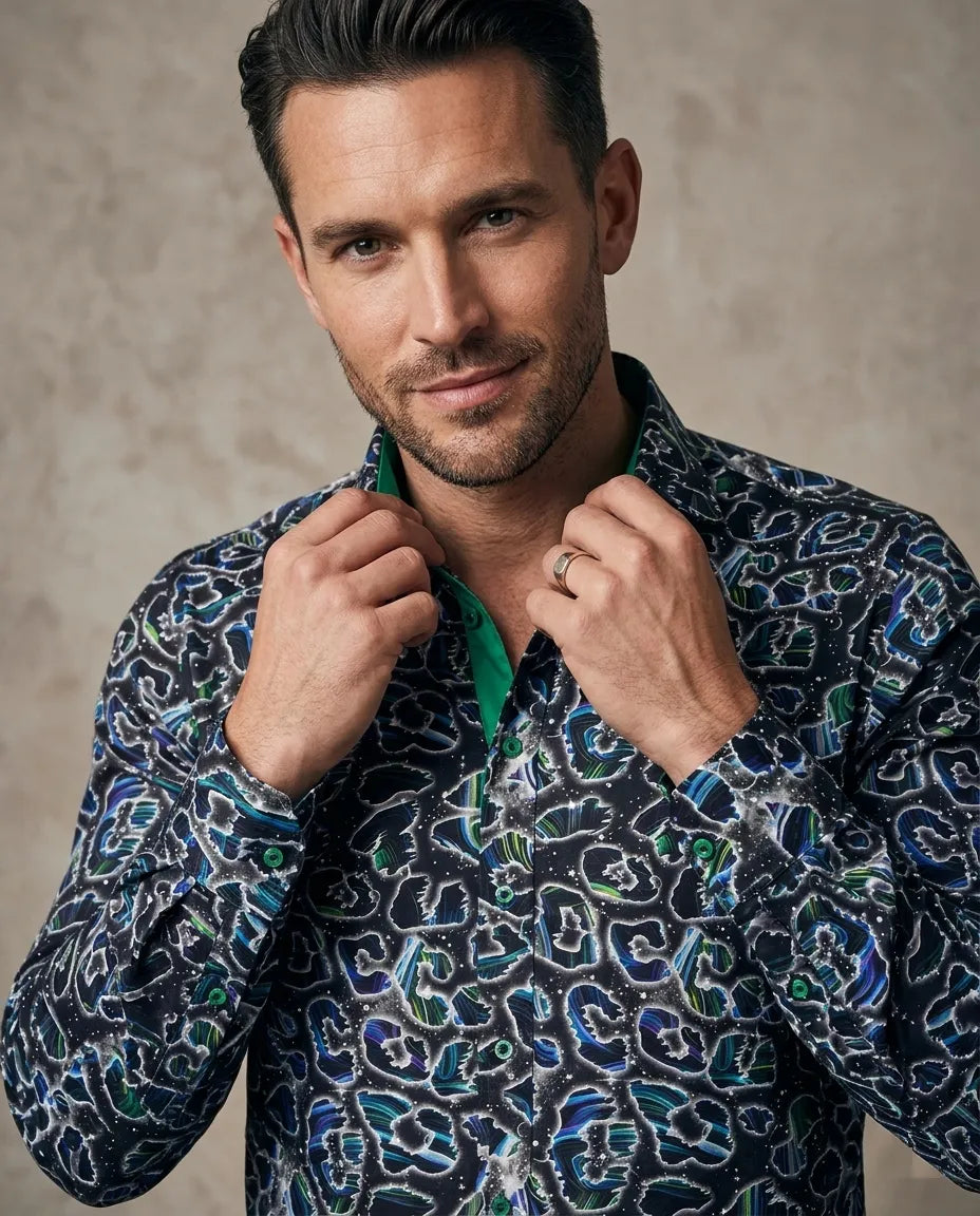 Man wearing a patterned shirt against a neutral background