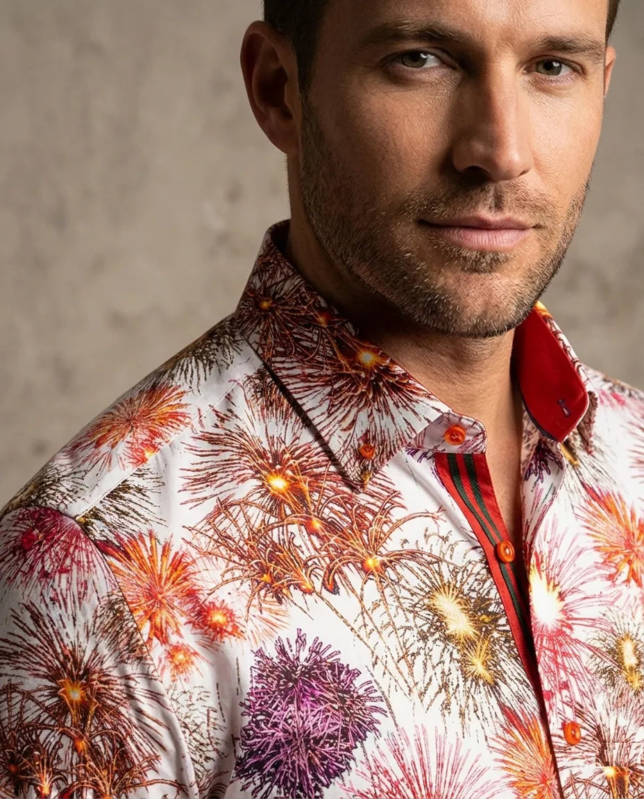 Man wearing a colorful floral shirt against a neutral background