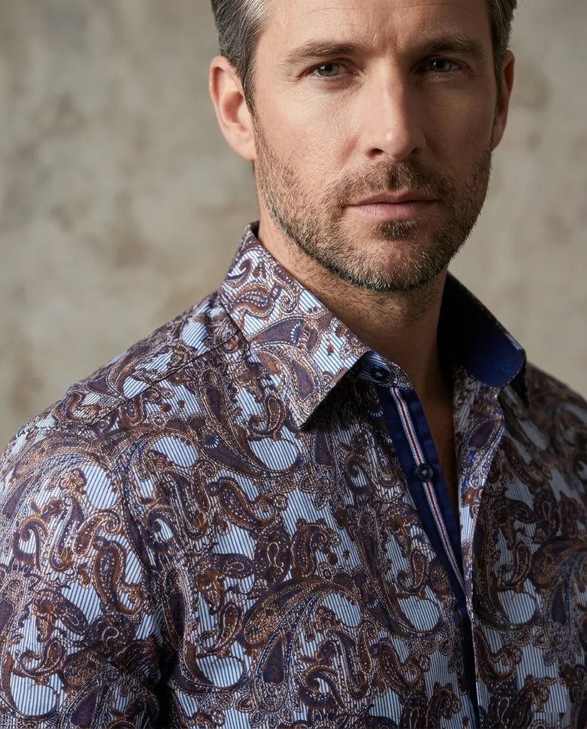 Man wearing a patterned shirt against a neutral background