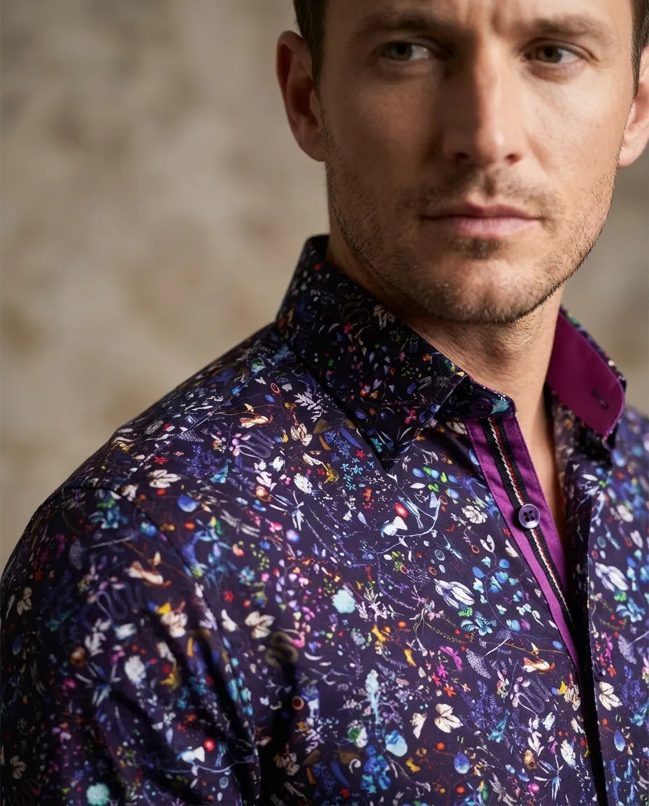 Man wearing a colorful floral-patterned jacket against a neutral background