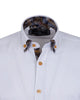 White dress shirt with patterned collar and cuffs on a white background